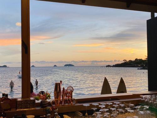 a view of the ocean from a bar with sharks in the water at Coconut Beach Resort, Koh Chang in Ko Chang
