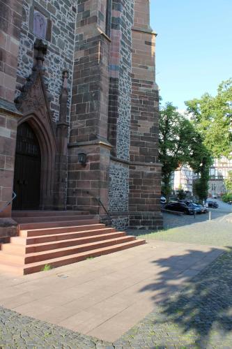 a large brick building with a door and some stairs at Ferienwohnung Stellberg in Homberg