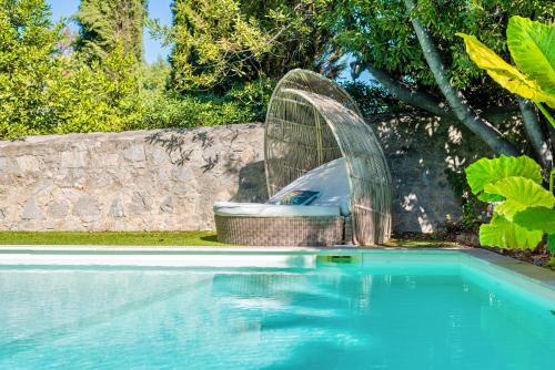 a swimming pool with a glass dome next to a swimming pool at Chambre d'hôtes de luxe, Toulon Mourillon, 4 belles chambres, Piscine in Toulon
