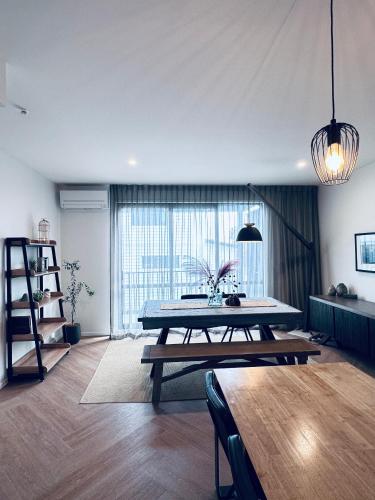 a living room with a table and a large window at Stylish Industrial Holiday House in Pakuranga Free Wifi Netflix in Auckland