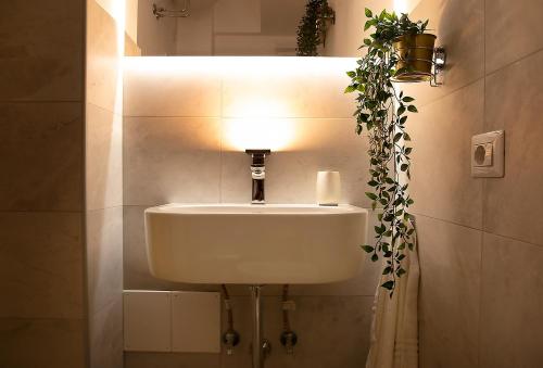 a white sink in a bathroom with a light at Luxury me in Rome
