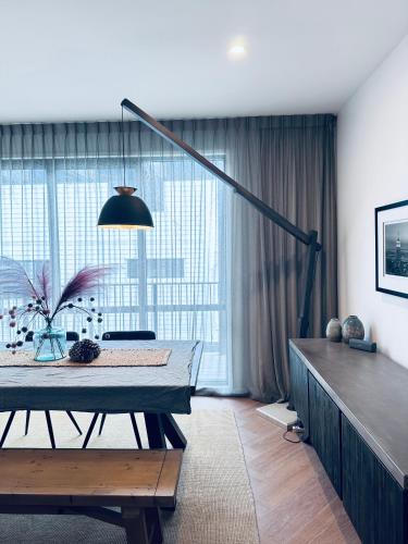a bedroom with a bed and a large window at Stylish Industrial Holiday House in Pakuranga Free Wifi Netflix in Auckland