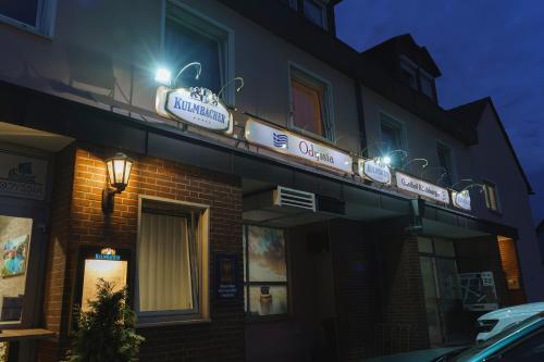 a building with a sign on top of it at night at Gasthof Kirchberger in Fürth