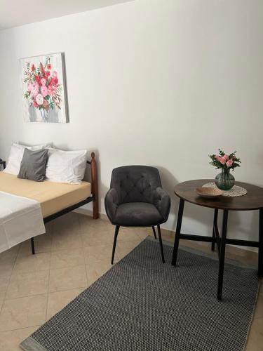 a bedroom with a bed and a chair and a table at Leyla in Vodice