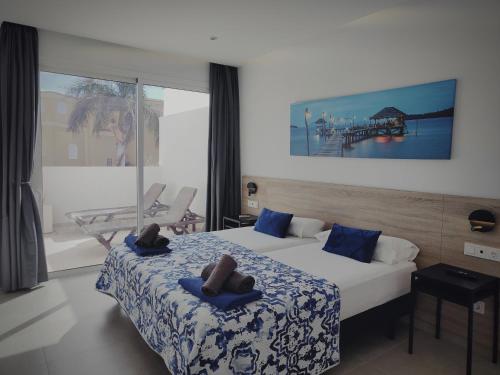 a hotel room with two beds with towels on them at Villa Palm Breeze in Maspalomas