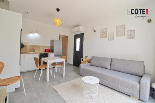 un salon avec un canapé et une table dans l'établissement LA PASTISSIERE BIS - 4 COUCHAGES, à Carry-le-Rouet