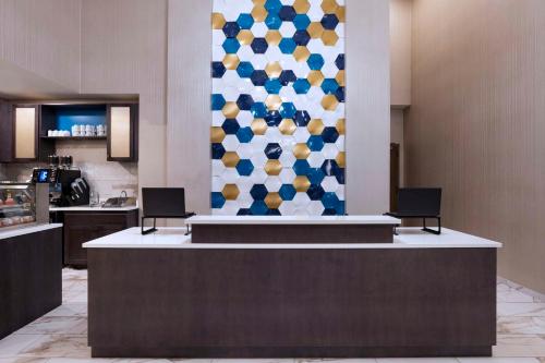 a lobby with a reception desk with two chairs at Hyatt Place Tulsa/Downtown in Tulsa