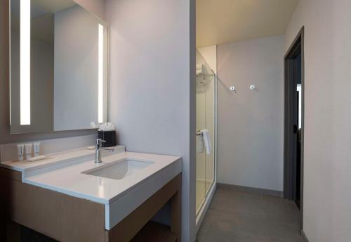 a bathroom with a sink and a shower at Hyatt Place Tulsa/Downtown in Tulsa