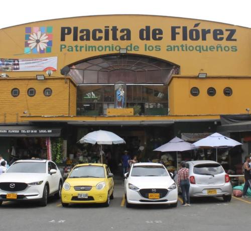 a group of cars parked in front of a building at Hermoso loft en medellin in Medellín