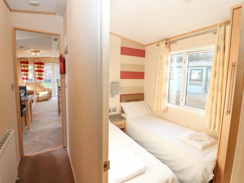 Llit o llits en una habitació de No 35 Meadows Retreat Lodge Park