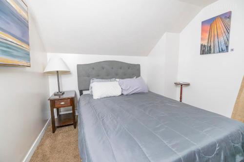 a small bedroom with a bed and a night stand at 1 BR - Parking - Amazing View Nearby! in Pittsburgh