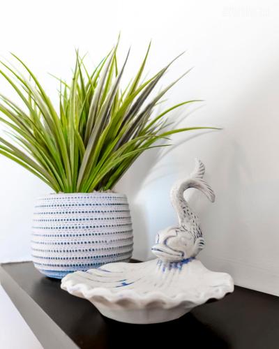 a vase sitting on a table next to a plant at 1 BR - Parking - Amazing View Nearby! in Pittsburgh