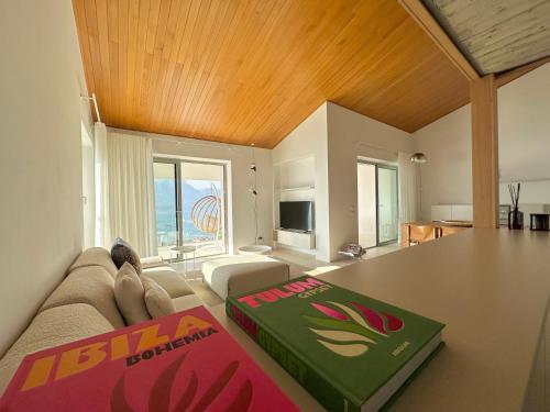 a living room with a table with a book on it at Villa Montagna in Torri del Benaco