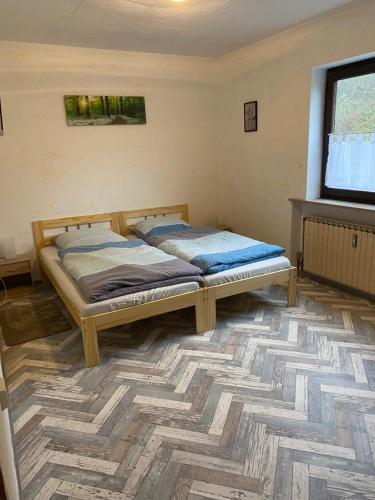 a bedroom with two beds in a room with a television at Gasthof zur Sägemühle in Hiltpoltstein