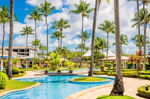 a resort with palm trees and a pool at Grand Oca Maragogi All Inclusive Resort in Maragogi