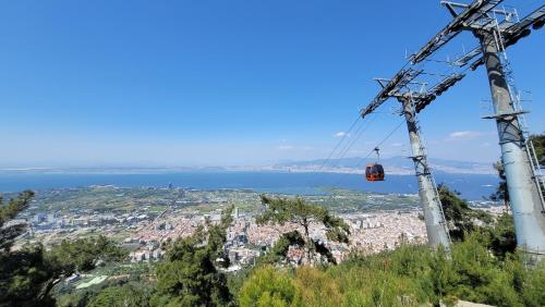 a gondola lift in the sky over a city at Wyndham Grand Izmir Ozdilek Thermal & Spa in Izmir