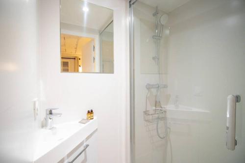 a white bathroom with a shower and a sink at 3p.cosy flat#6pers#heart of Le Marais in Paris