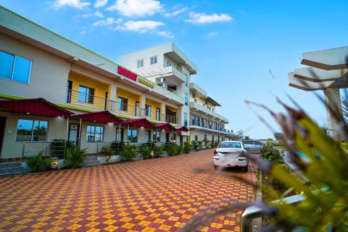 a car parked in front of a hotel at Holiday Beach Resort !! Beach Distance 50 Mts !! in Mandarmoni