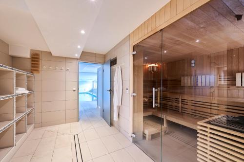 a bathroom with a walk in closet and a glass door at Nautic - 306 in Cuxhaven