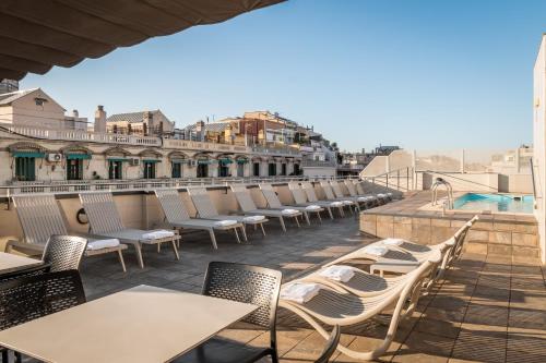 a row of tables and chairs on a roof at Sunotel Club Central in Barcelona