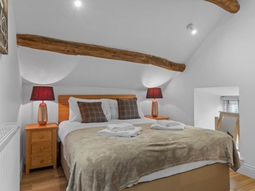 a bedroom with a large bed with two lamps at Pass the Keys 3 bed Cottage Above Beautiful Country Pub in Baycliff