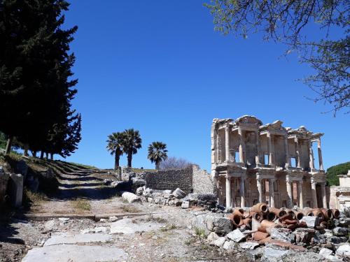 ancient ruins of a building with trees in the background at Wyndham Grand Izmir Ozdilek Thermal & Spa in Izmir