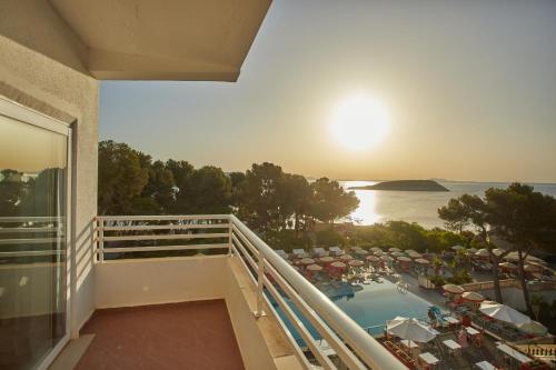 a balcony of a hotel with a view of a pool at Dreams Calvia Mallorca in Magaluf