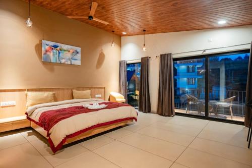 a bedroom with a bed and a large window at Cleveland Resorts Kanthalloor in Kanthalloor