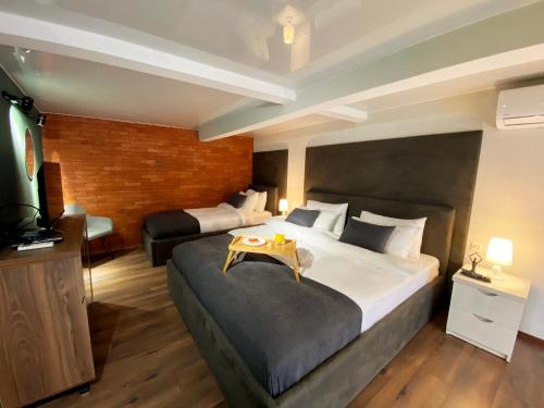 a hotel room with a large bed and a television at Luxury Duplex Studios - City Center in Tbilisi City