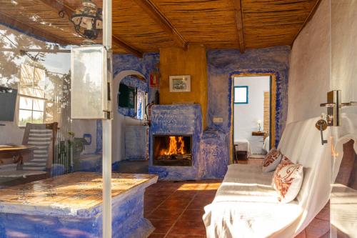 a living room with a couch and a fireplace at Casa Rural Aloe Vera in Huércal-Overa