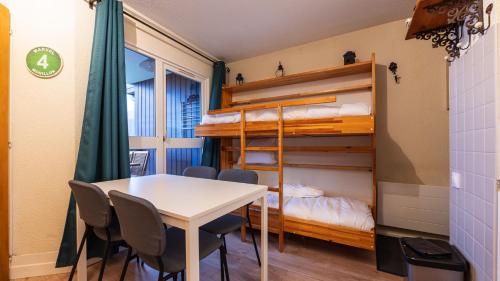 a room with a table and chairs and a bunk bed at Grande Neige 44 - Appt renove 4 pers in Morillon