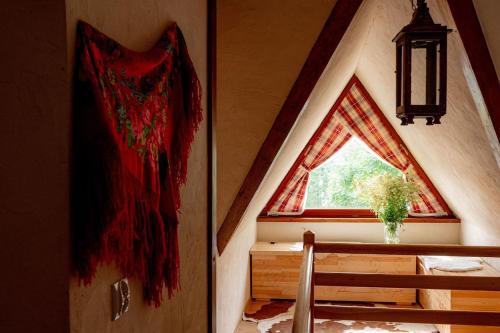 a room with a window and a table with a vase at Chałupa na wsi u Papierzy Sauna, Jacuzzi, SPA in Witów