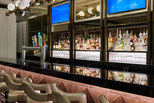 a bar with a row of chairs in a room at The Whitley, a Luxury Collection Hotel, Atlanta Buckhead in Atlanta