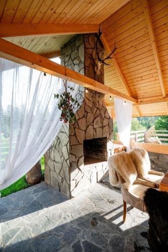 a stone fireplace in a pavilion with a stone at Chałupa na wsi u Papierzy Sauna, Jacuzzi, SPA in Witów