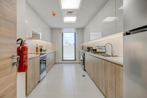 a kitchen with a red fire hydrant in it at #54 High End 2BR in Mirdif hills in Dubai