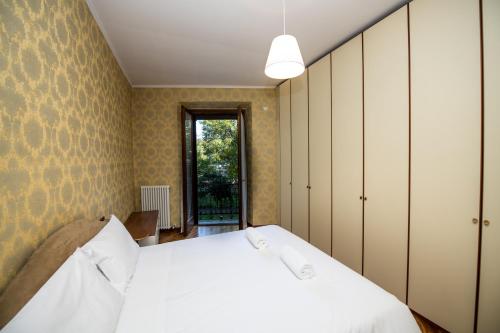 a bedroom with a white bed and a window at ShortMi Montello in Milan