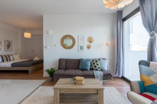 a living room with a couch and a table at Livia Studio Apartment in Larnaca in Larnaca