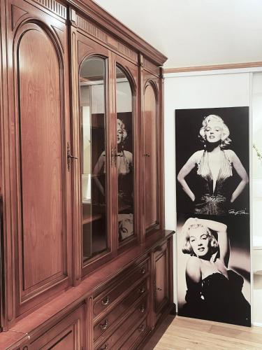 a wooden cabinet with a picture of a woman at Place Sainte Marguerite in Provins