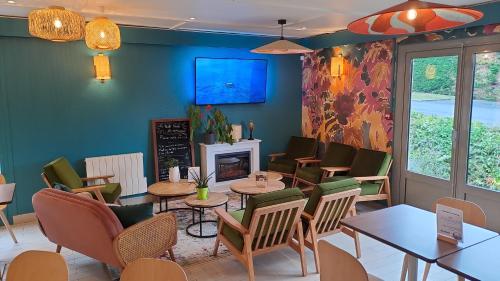 een restaurant met tafels en stoelen en een open haard bij KYRIAD HONFLEUR - La Riviere Saint Sauveur in Honfleur