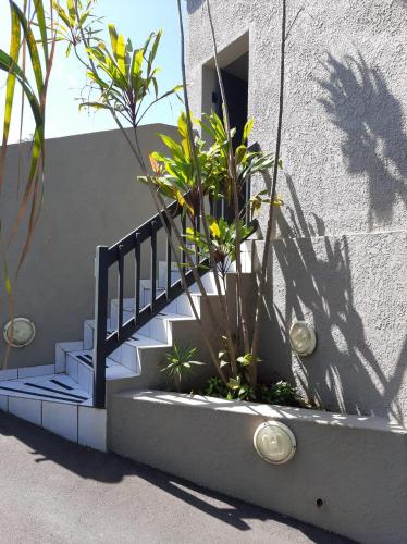 a staircase leading up to a building with plants at Studio @ 32 in Ballito