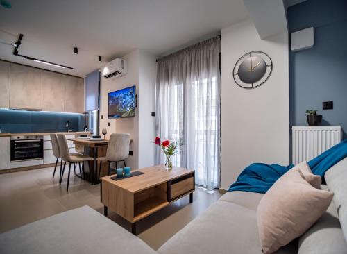 a living room with a couch and a table at Nestia urban apartments in Volos