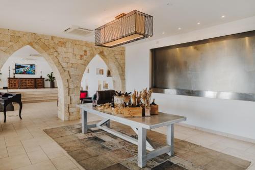 a dining room with a table and a large screen at Arkin Palm Beach Hotel in Mağusa