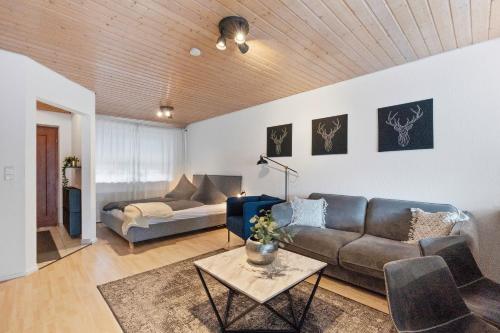 a living room with a couch and a table at Apartment Bodman in Friedrichshafen in Friedrichshafen