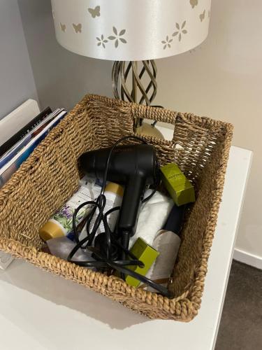 a basket sitting on a table with a lamp and a lamp at Bumble’s Barn in Slamannan