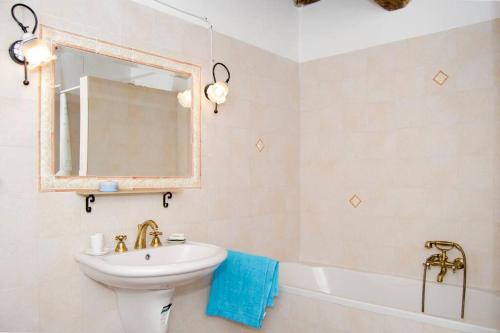 a bathroom with a sink and a mirror and a tub at THE REAL TUSCANY in Casabasciana