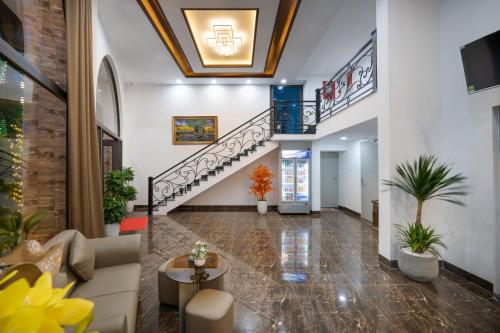a lobby with a staircase and a living room at Moskva Motel & Apartment Danang in Da Nang