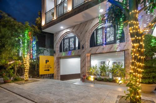 a building with christmas lights in front of it at Moskva Motel & Apartment Danang in Da Nang