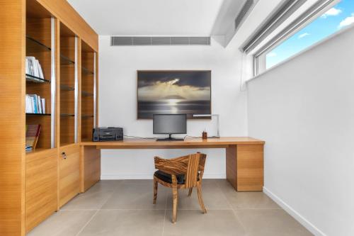 a home office with a desk and a chair at Villa Artemis - New Magnificent Beachfront Villa with Infinity Pool! in Kranidi