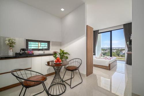 a kitchen and living room with a table and chairs at Moskva Motel & Apartment Danang in Da Nang