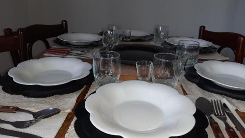 a table with white plates and glasses on it at Poiana Stelelor in Văleni